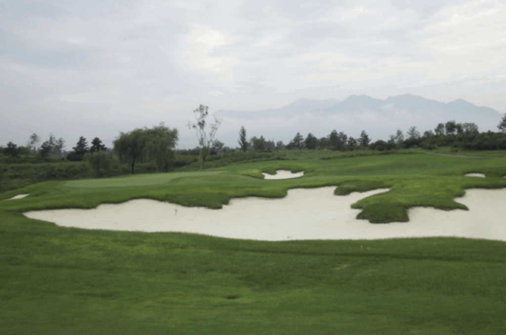 Golf course with ball near flag
